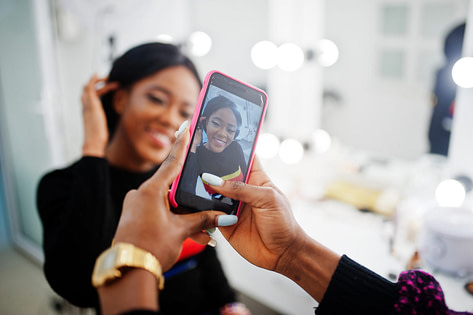 Hair salon makeover for salon marketing Hairstylist taking camera photo of client for social media marketing campaign